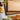 Two blank personalized cutting boards—one maple and one walnut—stacked together on a clean white surface surrounded by natural food elements. Green and red grapes, cubes of cheddar cheese, golden crackers, and fresh heirloom carrots with greens create a warm, inviting kitchen scene. These premium wood boards are ideal for engraving custom designs, perfect as wedding gifts, anniversary keepsakes, or functional cutting board gifts for home chefs and families.