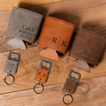 Personalized leather wallets and keychains on a wooden surface