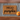 Doormat with 'HELLO pumpkin' text on a striped background with a small pumpkin.