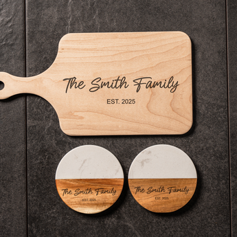 Wooden cutting board and coasters with 'The Smith Family' engraving on a dark surface