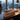 Wooden nameplate on a desk with a cityscape view